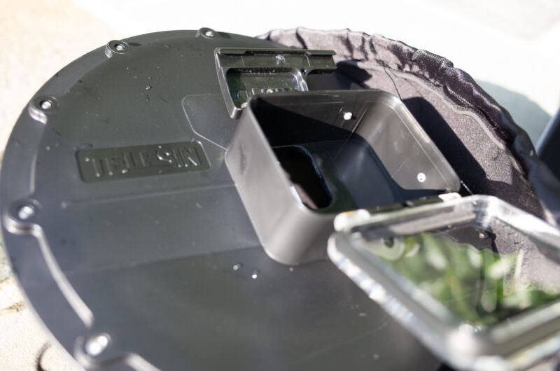 Back of a GoPro dome port showing the built-in camera tray sized for a HERO5 Black