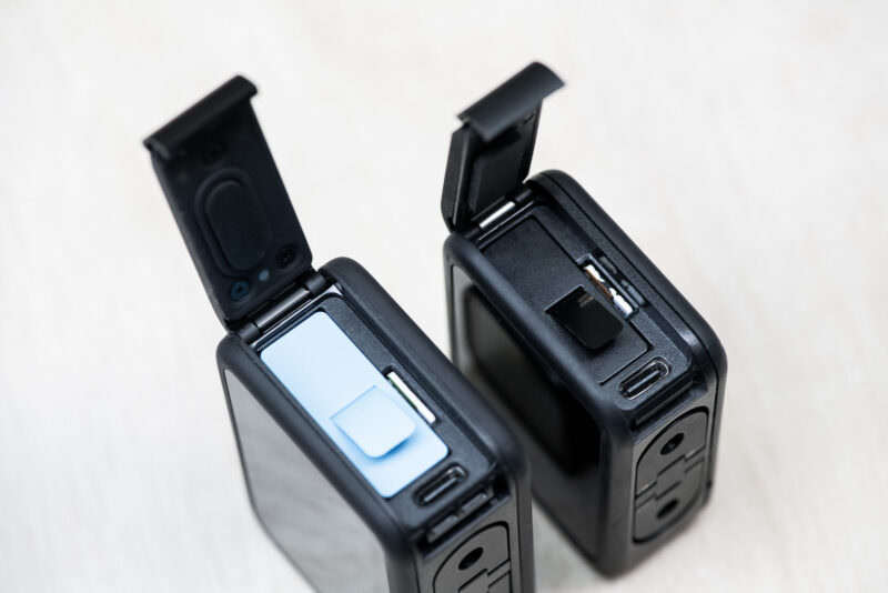 Side-by-side comparison of GoPro HERO9 Black and HERO8 Black open side door compartments with micro-SD and USB-C ports