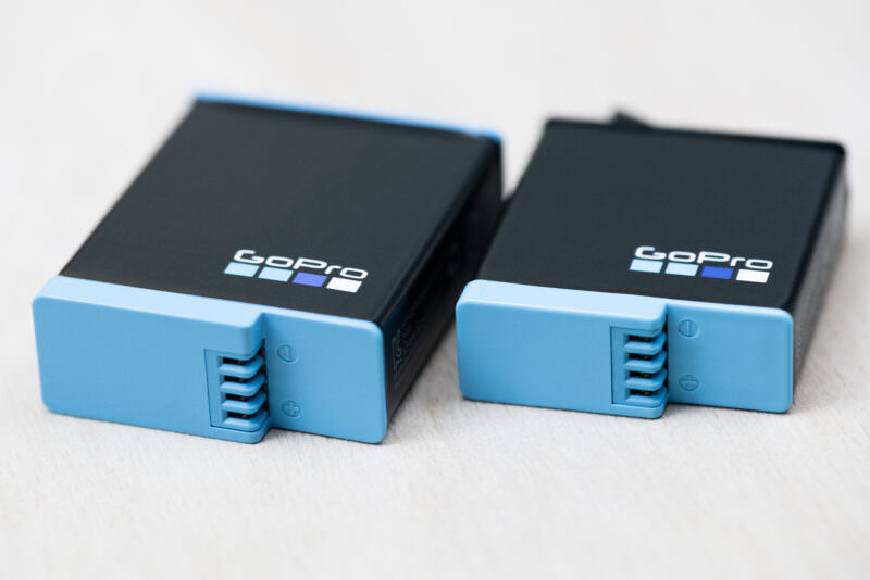 GoPro HERO9 Black and HERO8 Black batteries angled to show their blue connector prongs and differing sizes