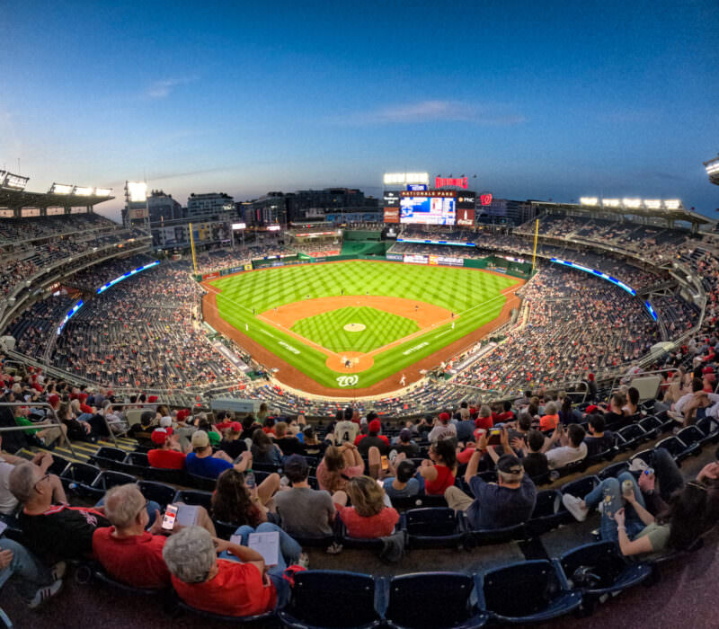 Fisheye view over Nationals Park in Washington DC with fans filling the stands at dusk under stadium lights