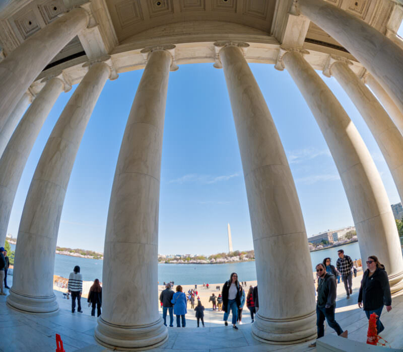 Fisheye view through the Jefferson Memorial's curved colonnade toward the Washington Monument