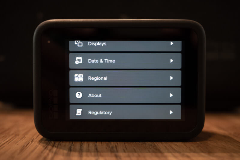 GoPro HERO settings menu on its touchscreen showing Displays, Date & Time, Regional, About, and Regulatory options