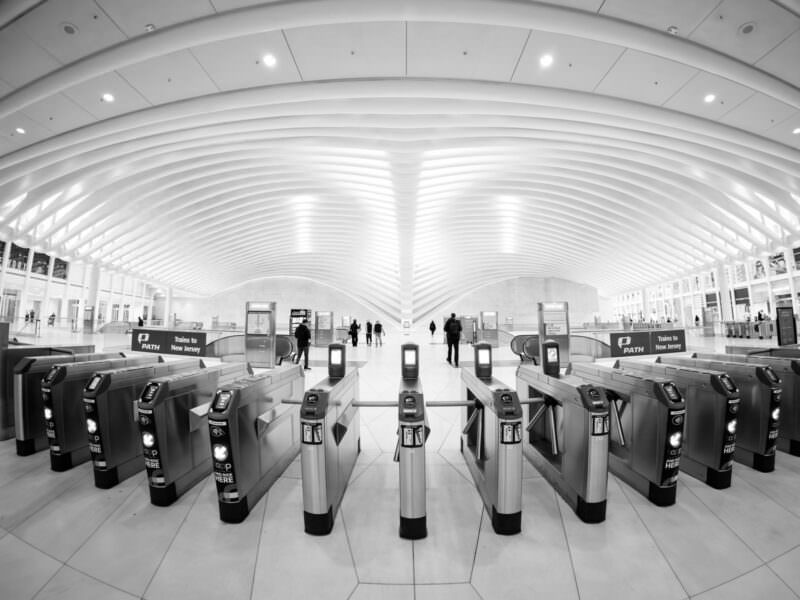 Black-and-white sample photo from the Insta360 Ace Pro 2 of PATH turnstiles inside the Oculus
