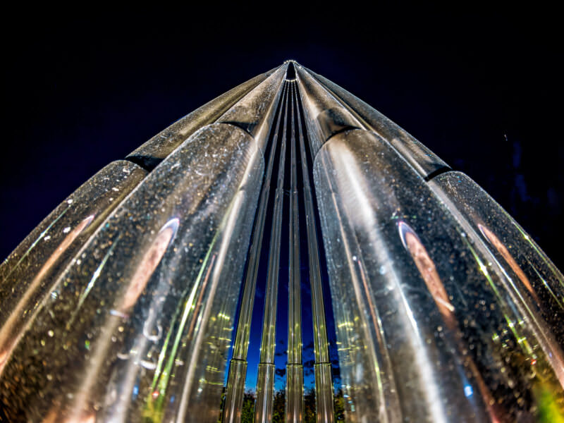 Night sample shot from the Insta360 Ace Pro 2 of illuminated metal sculpture spires against a dark sky