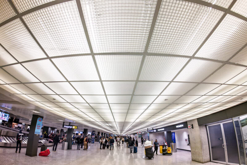 Sample image from the Insta360 Ace Pro 2 of a bright airport baggage claim hall filled with travelers