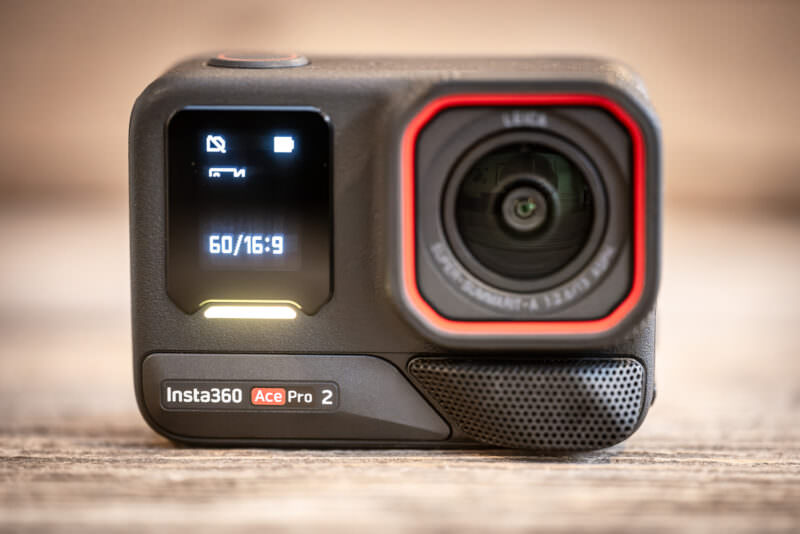 Insta360 Ace Pro 2 action camera front view with Leica lens, red ring, and flip-up touchscreen display