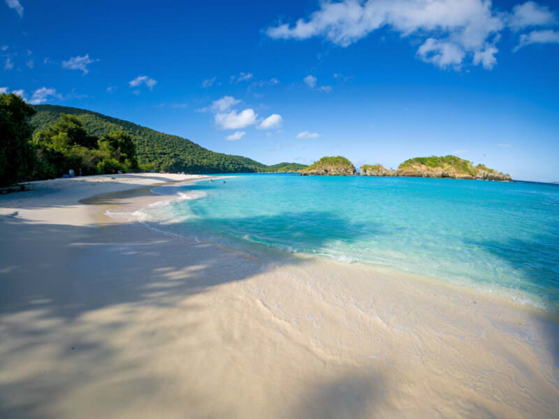 Sample image from the Insta360 Ace Pro 2 of a quiet Caribbean beach with turquoise water and green hills