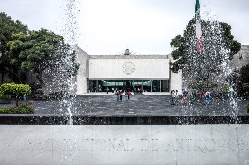 Museo Nacional de Antropología entrance with water cascading from el paraguas canopy, single bronze-clad column visible