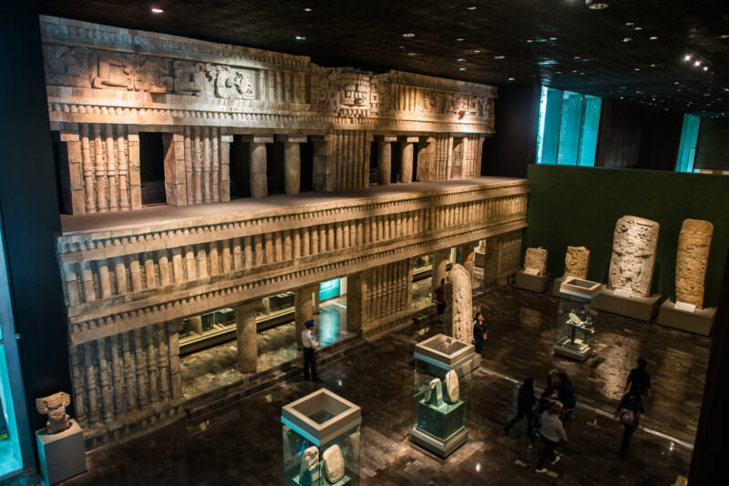 Sala Maya with full-scale Palace of Palenque facade reproduction rising two stories above floor of Maya stelae and relief panels