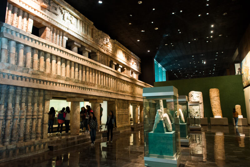 Sala Maya with monumental Puuc-style palace facade reconstruction, two tiers of cylindrical colonnettes and carved friezes
