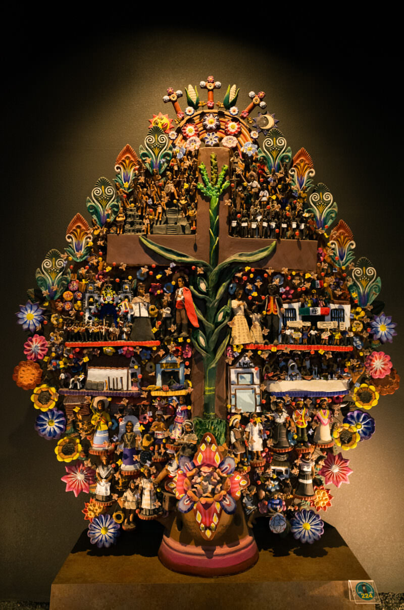 Árbol de la Vida ceramic sculpture densely populated with miniature figures, flowers, cross, and corn stalk
