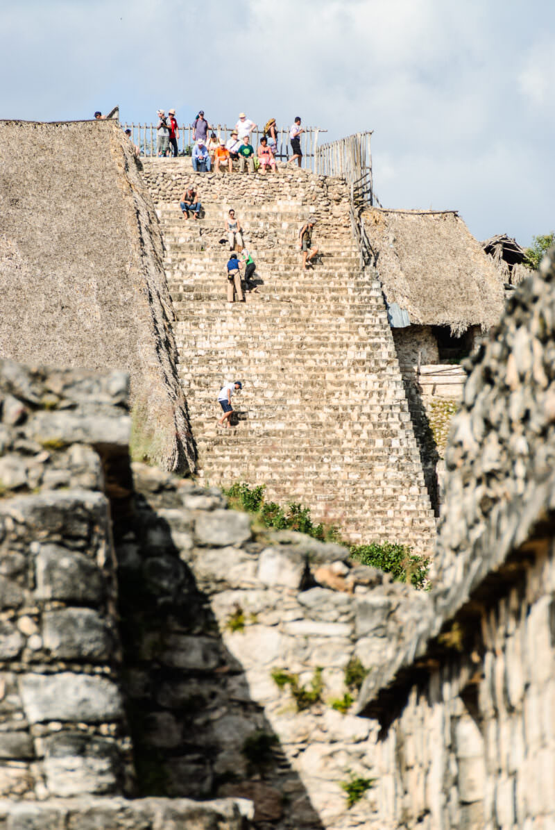Tourists ascending and descending the near-vertical main staircase of Ek' Balam's Acropolis