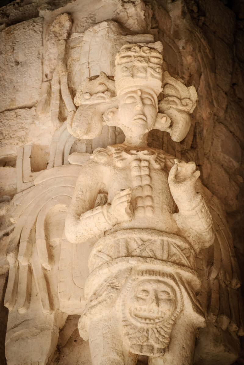 Near-life-sized winged figure from the Sak Xok Naah at Ek' Balam, with elaborate headdress and ritual costume