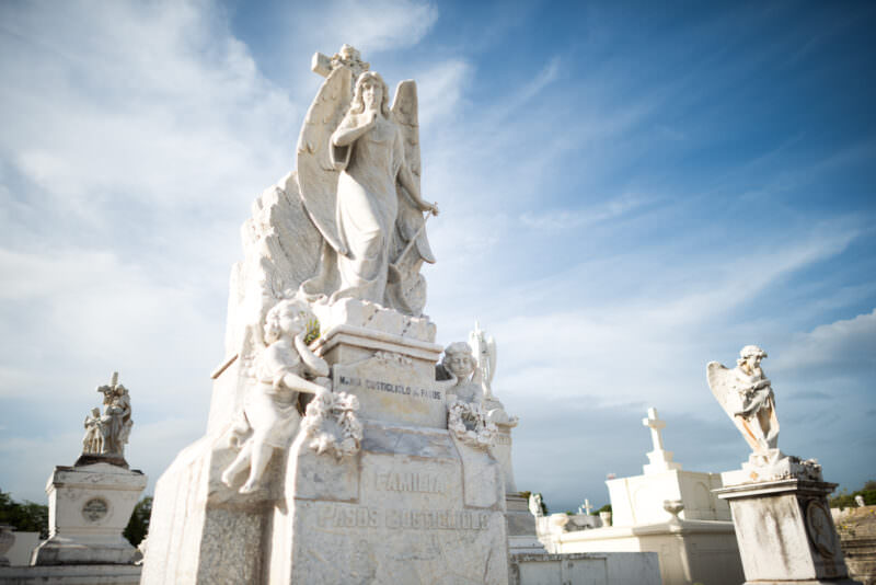 White marble angel with inverted torch atop the Pasos Costigliolo family tomb in Granada Municipal Cemetery