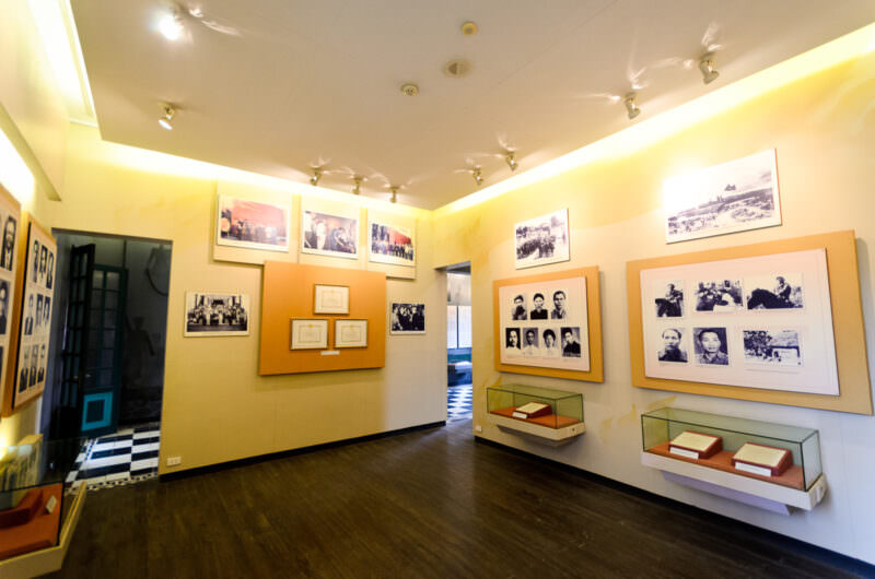 Archival photographs and framed documents in a Hoa Lo Prison exhibit gallery