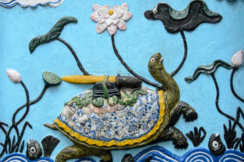 Ceramic mosaic relief at Ngoc Son Temple depicting the golden turtle carrying a sword