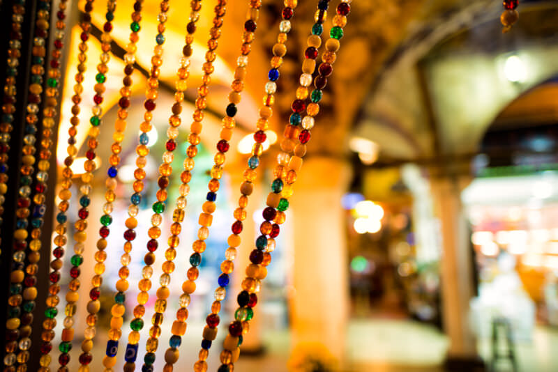 Colorful bead curtain framing the entrance to a tea house within the covered arches of the Grand Bazaar