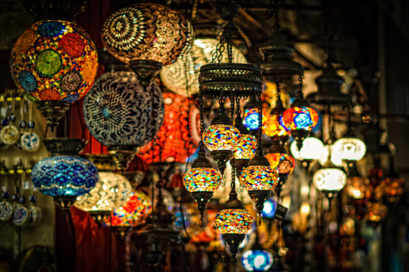 Globe and geometric mosaic glass lamps hanging from the ceiling of a Grand Bazaar shop