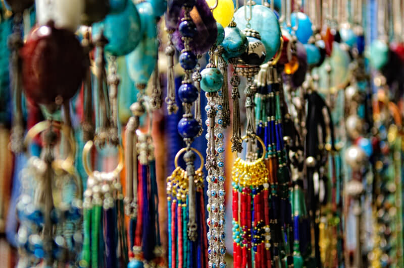 Turquoise beads and nazar evil-eye amulets hanging densely at a Grand Bazaar jewelry stall