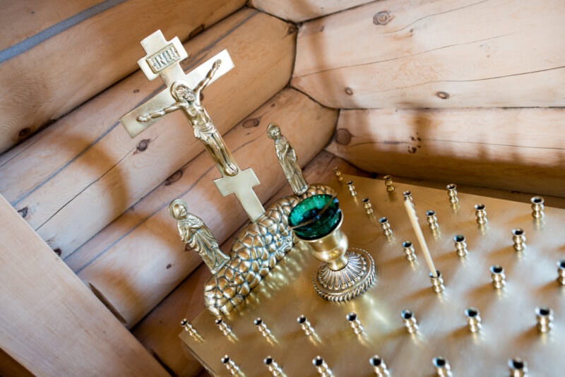 Eastern Orthodox crucifix displayed in blue and gold interior of Trinity Church, Bellingshausen Station, King George Island