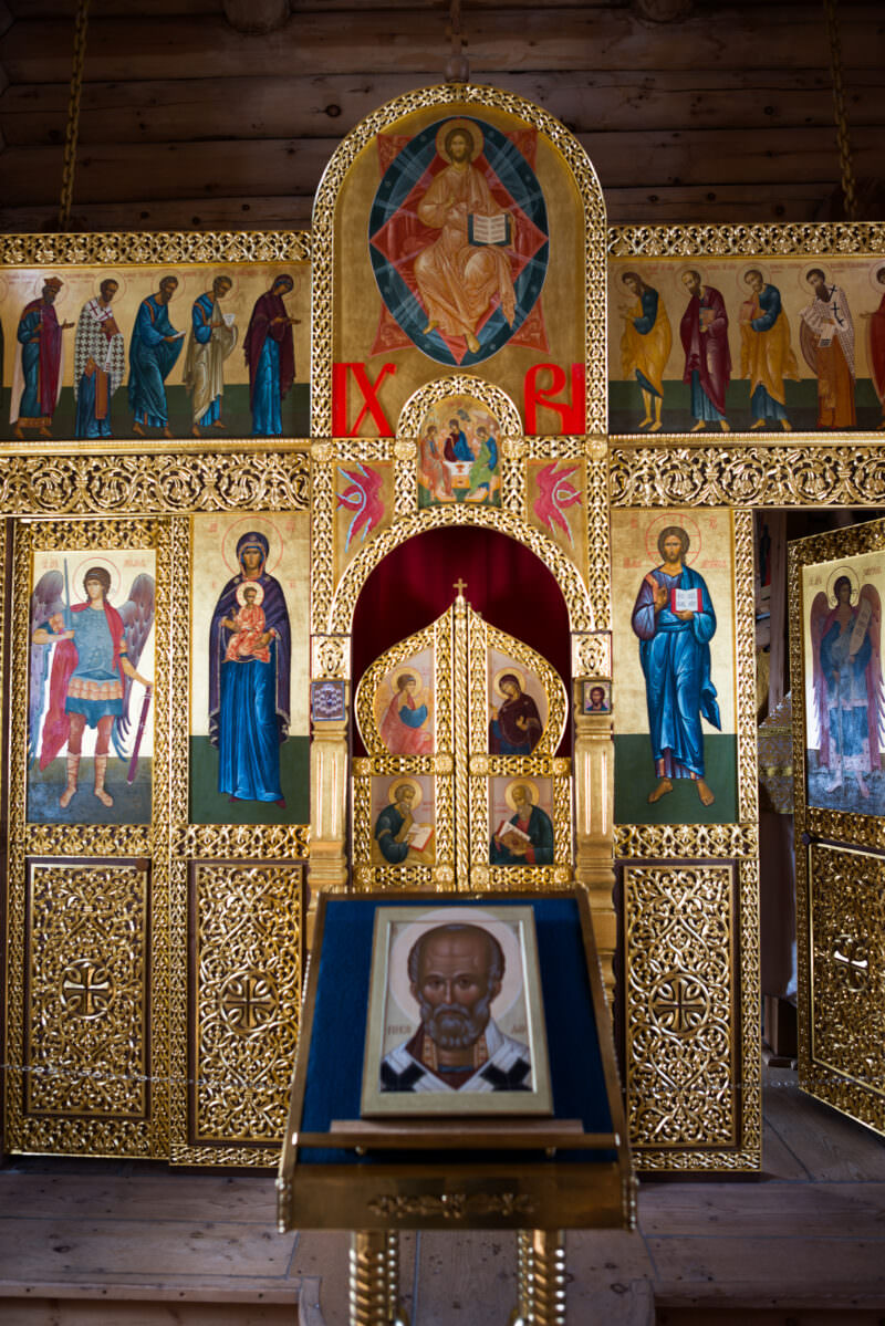 Close view of painted icons and gilded woodwork on the iconostasis at Trinity Church, King George Island