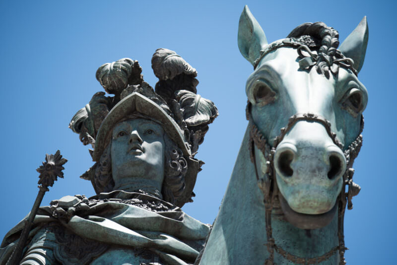 Close-up of the bronze equestrian statue's helmeted rider and horse's head in Praça do Comércio