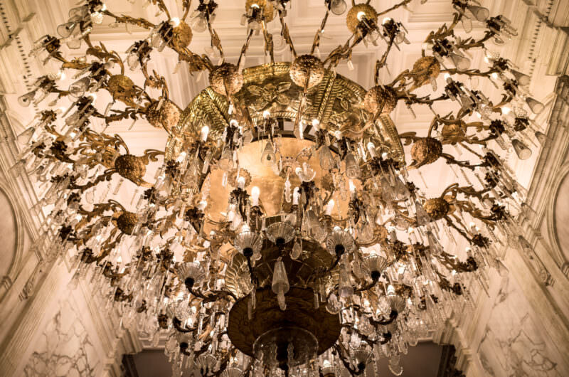 Elaborate crystal chandelier with branching arms at Gran Hotel Ciudad de Mexico, suspended beneath a coffered dome