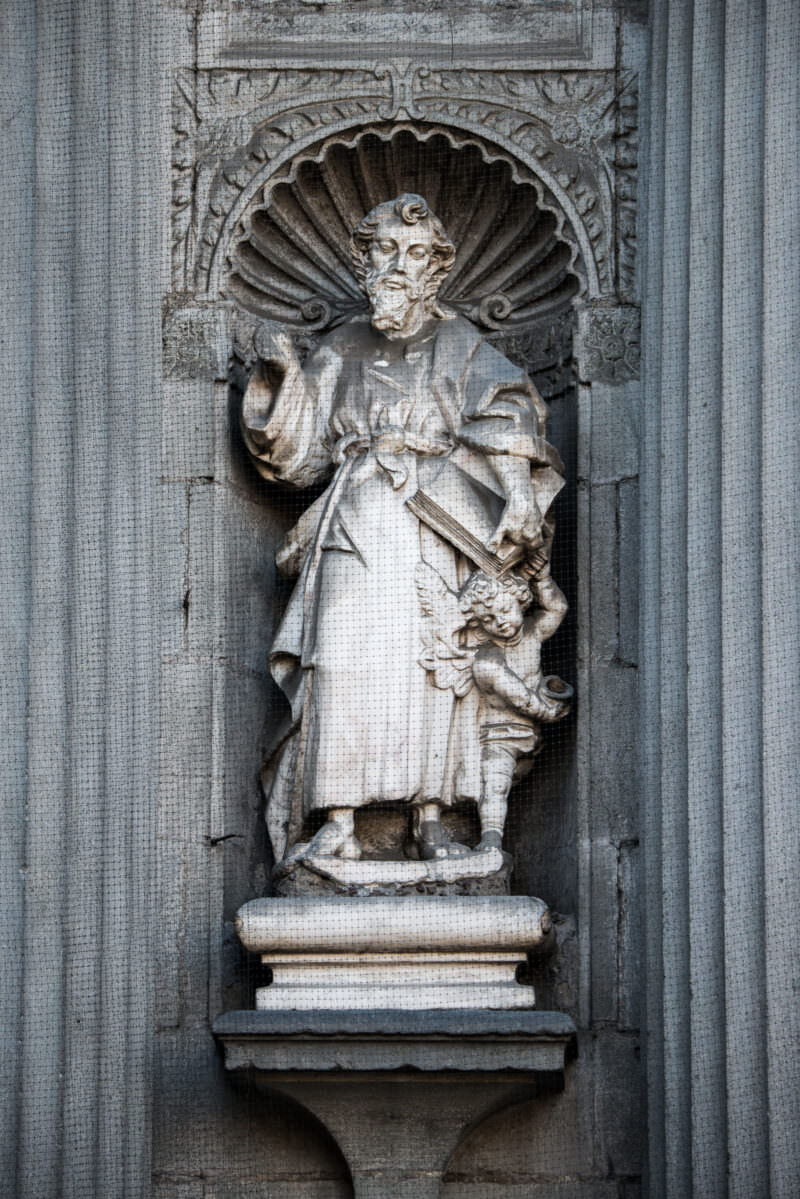 Chiluca stone apostle figure in a shell-canopied niche on the cathedral's south facade