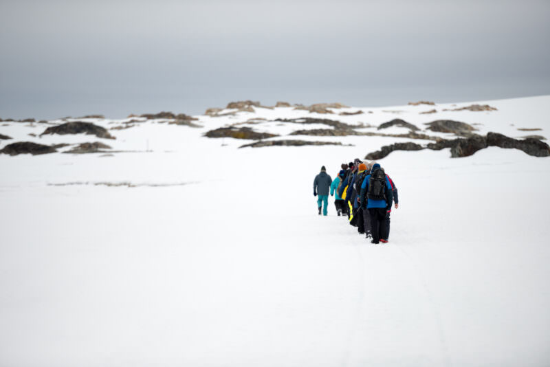 Wordie House Tourists Walking On Sea Ice Winter Island Antarctica