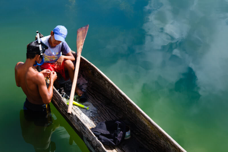 Lake Peten Itza Boys Fishing From Canoe Flores Guatemala