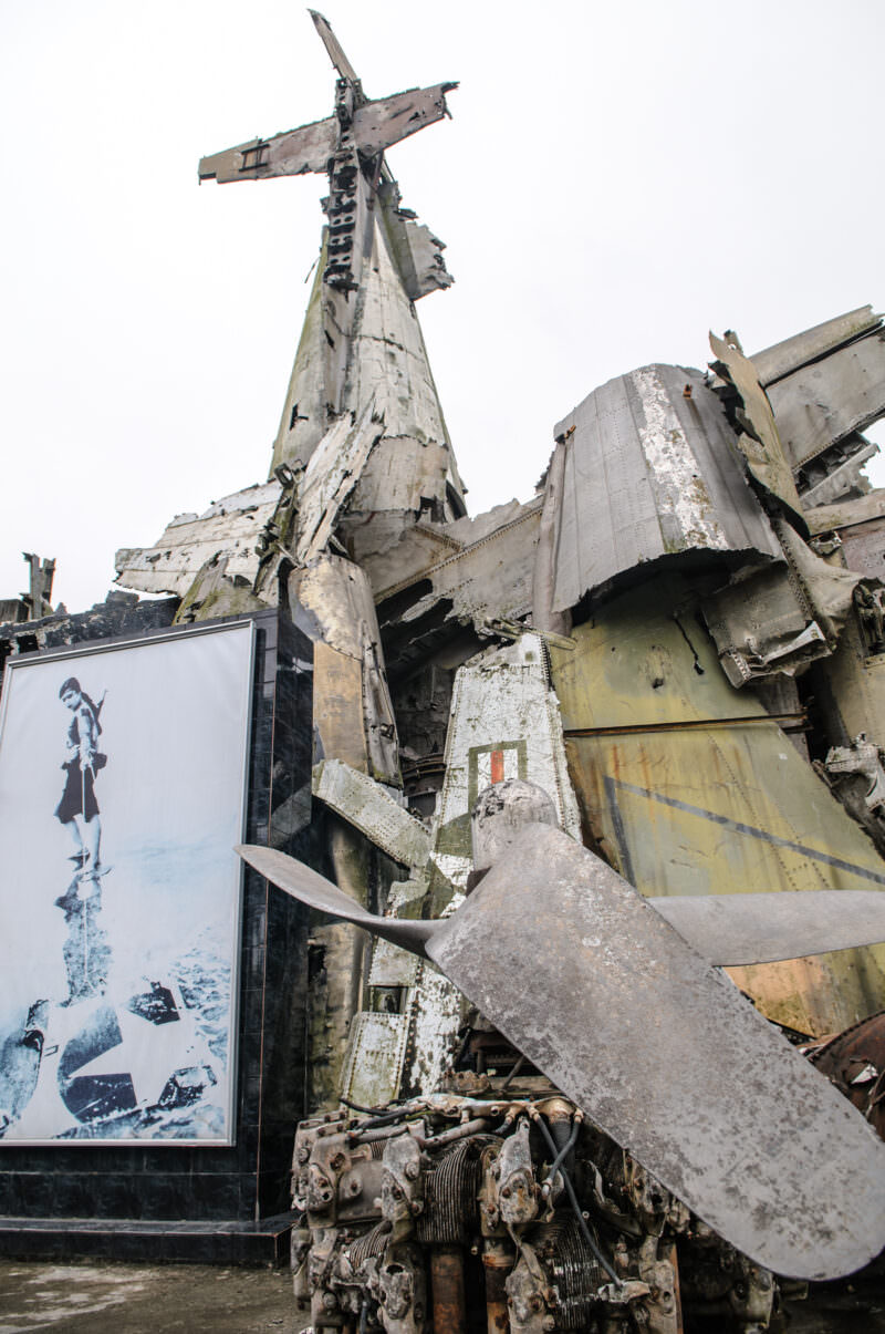 Twisted B-52 wreckage and radial engine forming a jagged monument at the Vietnam Military History Museum