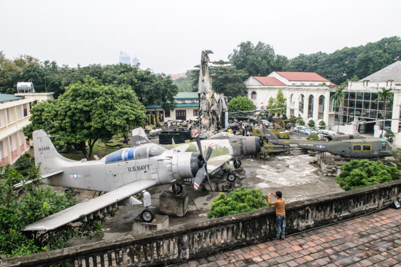 Captured U.S. Navy A-1 Skyraider and wreckage monument seen from the Hanoi Flag Tower terrace