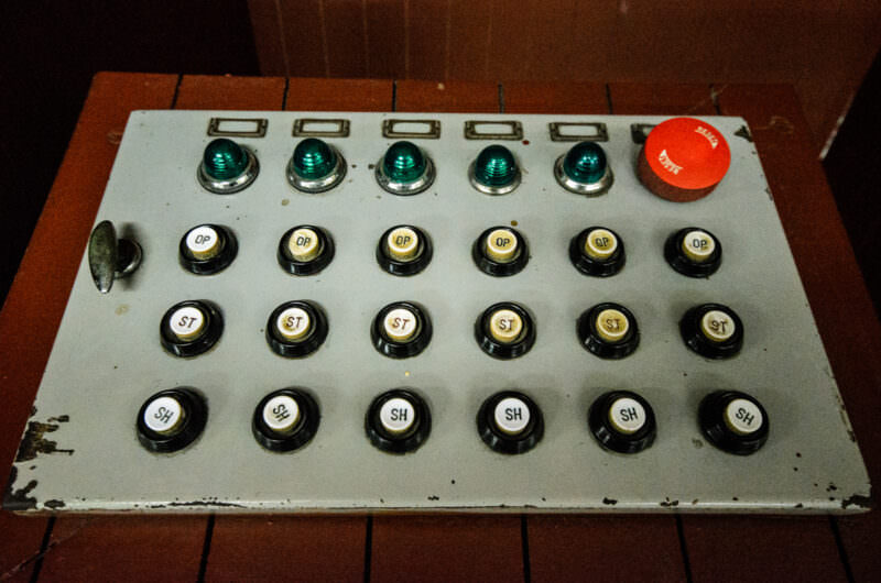 Vintage enameled metal switchboard with buttons and indicator lights in Reunification Palace's bunker