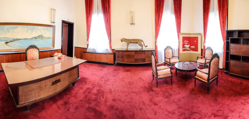 Red-carpeted office with taxidermy leopard and desk in President Thiệu's preserved study at Reunification Palace