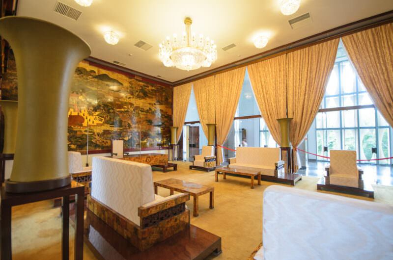 Gold lacquerware mural and mid-century seating in Reunification Palace's State Reception Room