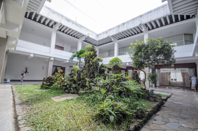 Open-air courtyard with a rock garden landscape amid the residential quarters of Reunification Palace