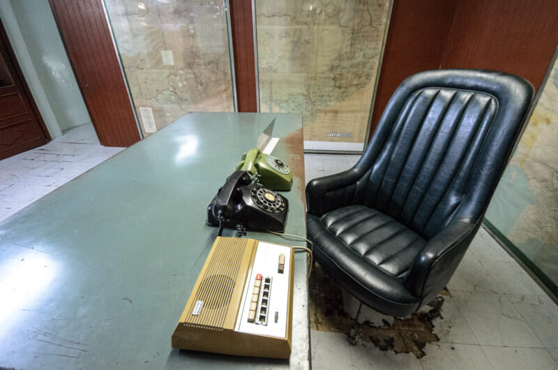 Metal desk with rotary phones and intercom in President Thiệu's preserved War Room at Reunification Palace