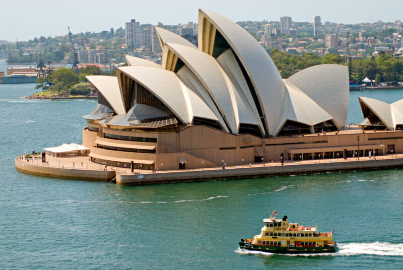 Passenger ferry crossing Sydney Harbour in front of Sydney Opera House vaulted roof
