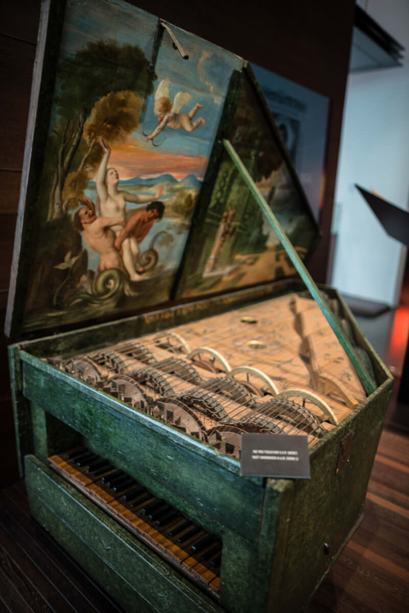 Geigenwerk dated 1625, green painted lid open revealing rosined wheels and strings inside bowed keyboard mechanism