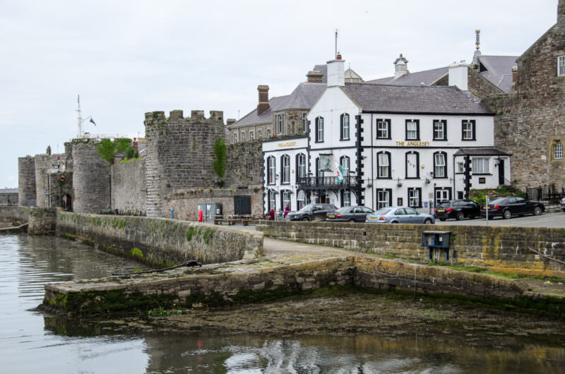 Anglesey pub sitting against curtain walls of Caernarfon Castle