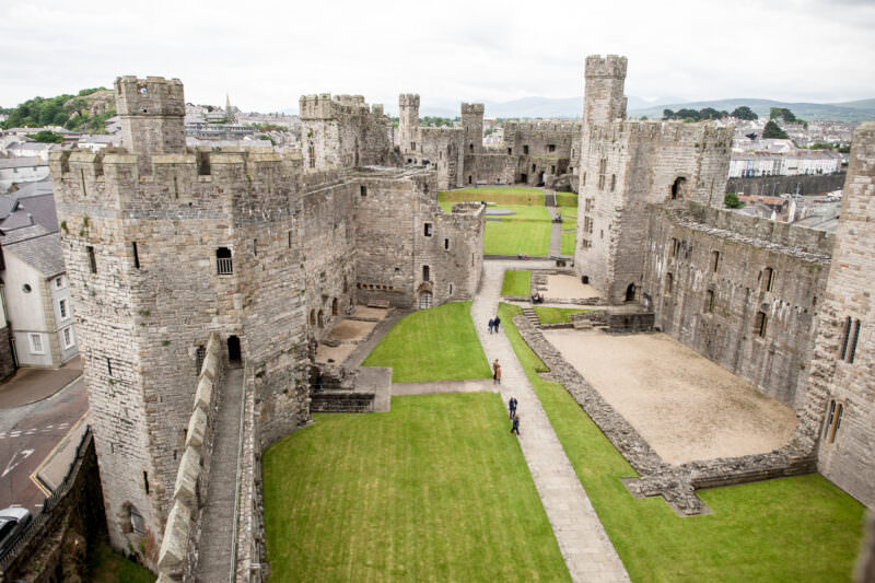 Interior courtyard viewed from battlements showing polygonal towers and banded masonry