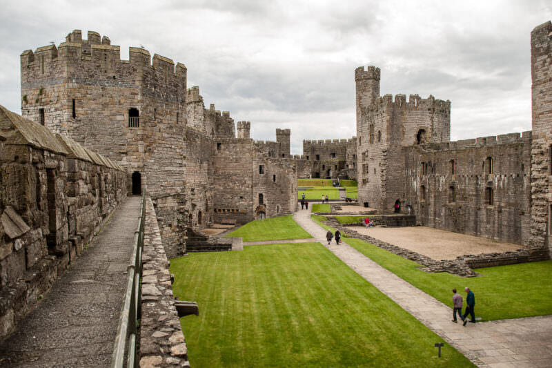 Open courtyard displaying polygonal towers at Caernarfon Castle