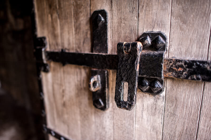 Solid oak door fitted with heavy metal lock at Caernarfon Castle