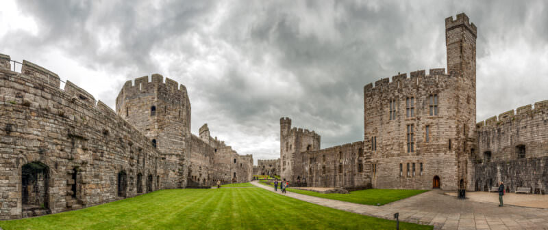 Polygonal towers and banded masonry in Caernarfon Castle's interior courtyard