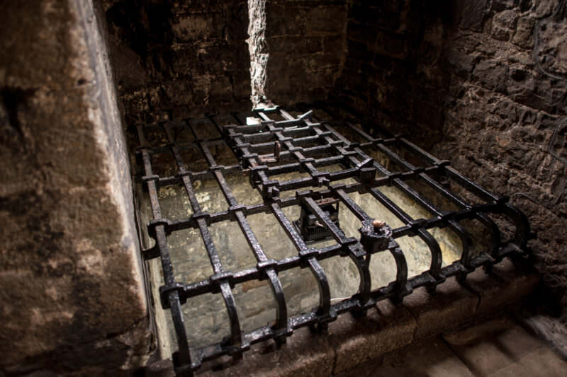 Black metal grill covering original water well at Caernarfon Castle