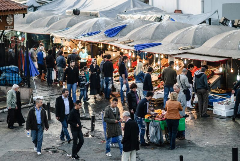Shoppers browse tented stalls at the Karaköy Fish Market beside the Galata Bridge on the Golden Horn