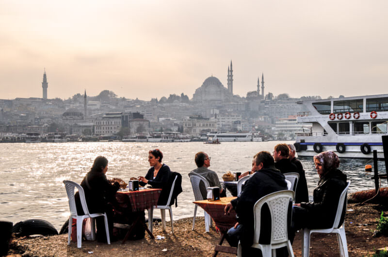 Diners at plastic tables on the Karaköy shore watch the Süleymaniye Mosque silhouette across the Golden Horn