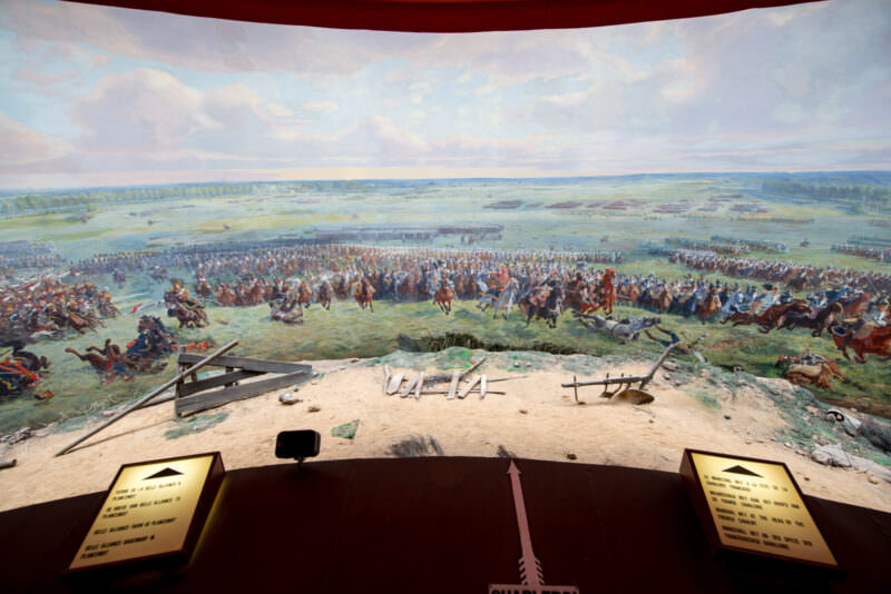 Interior view of Panorama canvas showing cavalry charges, with faux-terrain and illuminated plaques on central platform