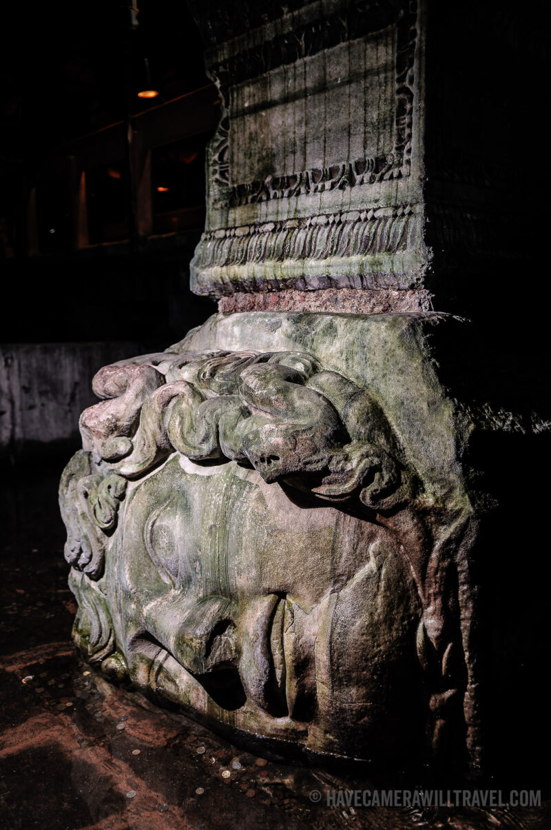 Sideways Medusa head sculpture forming the base of a column in the Basilica Cistern