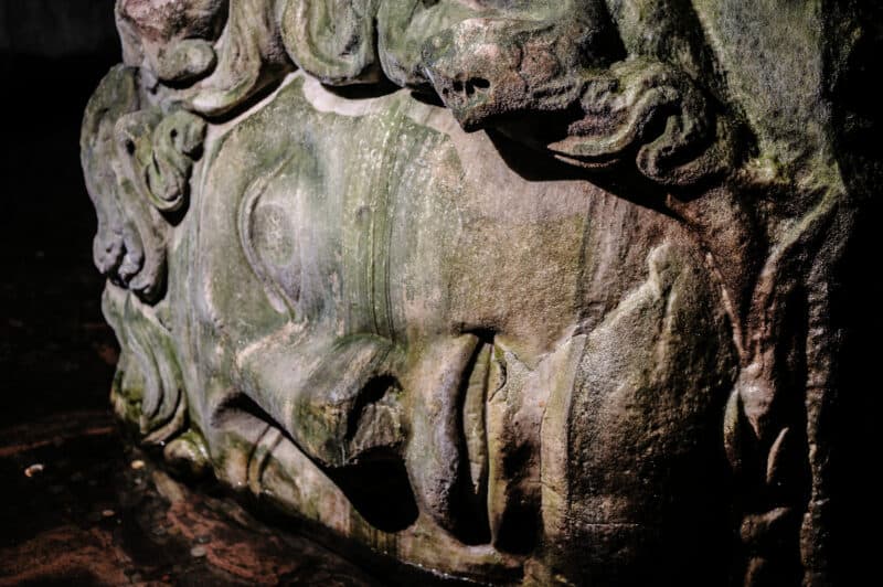 Weathered Medusa head carving forming the base of a column in the Basilica Cistern